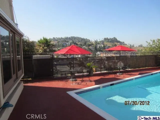 an outdoor space with pool and furniture
