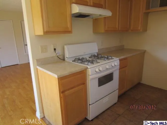 a kitchen with a stove and cabinets