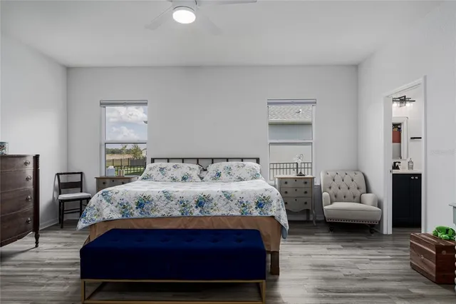 a bedroom with a bed mirror and couch
