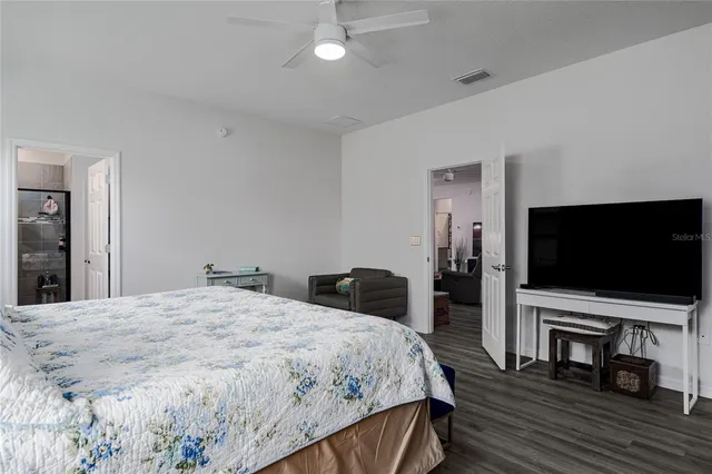 a bedroom with a bed and a flat screen tv