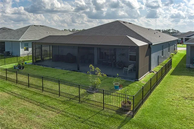 a view of house with backyard