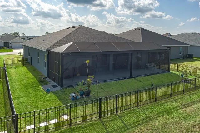 a view of house with backyard and garden