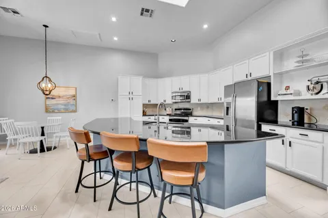 a kitchen with stainless steel appliances granite countertop a sink and dishwasher a stove with wooden floor