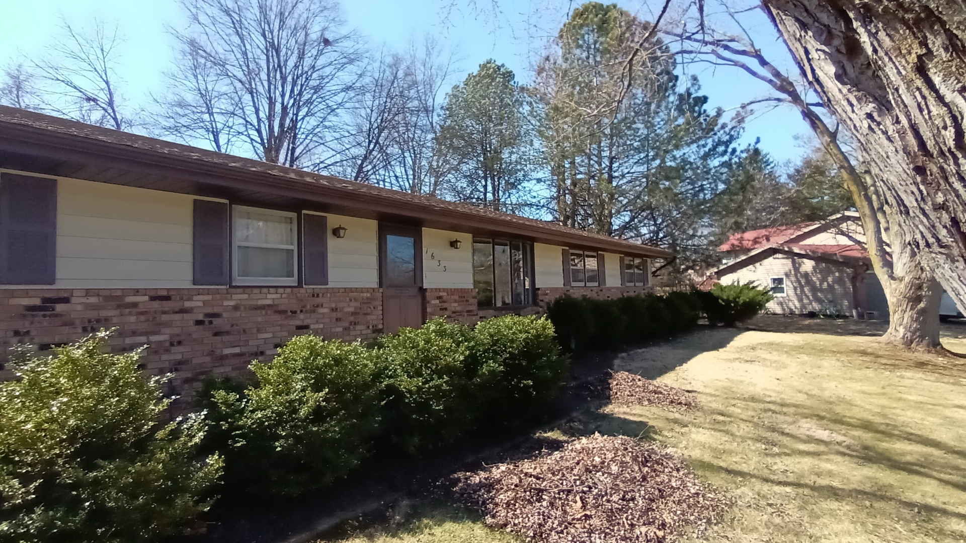 1633 Erin Drive Normal, IL 61761 - Photo 3 of 46 a front view of a house with a yard and shrubs