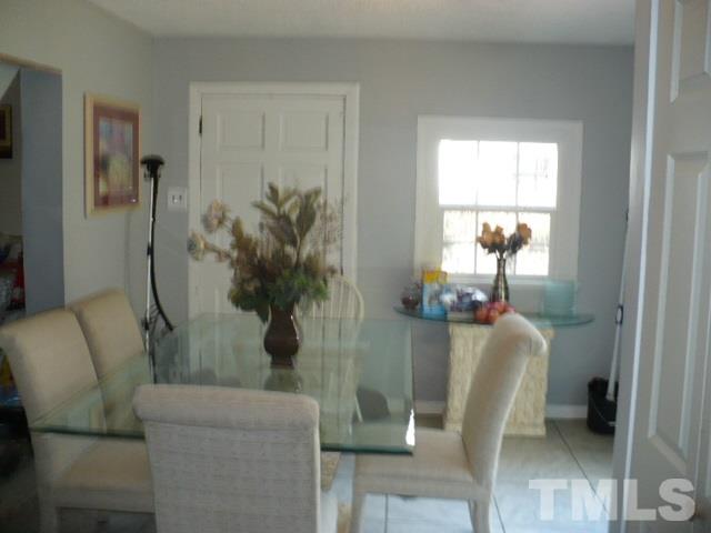 1311 Bethel Road Raleigh, NC 27610 - Photo 12 of 24 a living room with furniture and a potted plant
