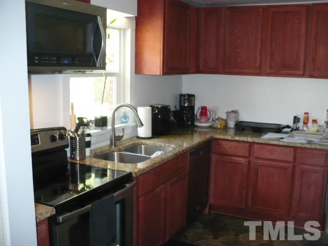 1311 Bethel Road Raleigh, NC 27610 - Photo 14 of 24 a kitchen with sink a microwave and cabinets