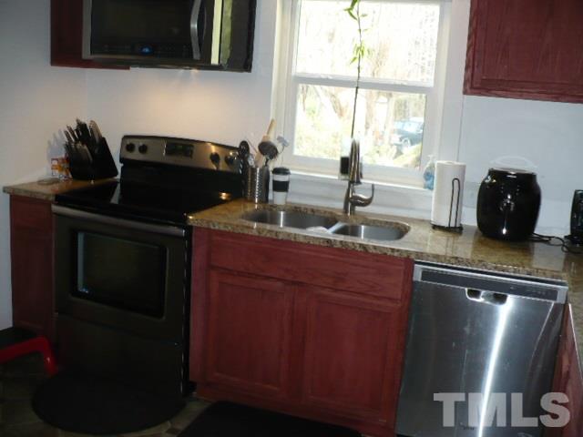 1311 Bethel Road Raleigh, NC 27610 - Photo 16 of 24 a kitchen with a sink and a microwave