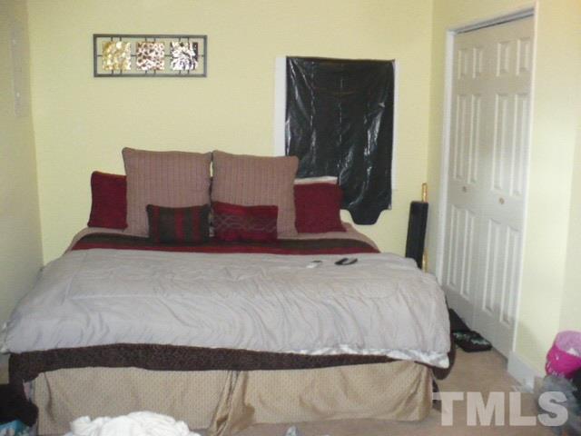 1311 Bethel Road Raleigh, NC 27610 - Photo 17 of 24 a bedroom with a bed and wooden floor
