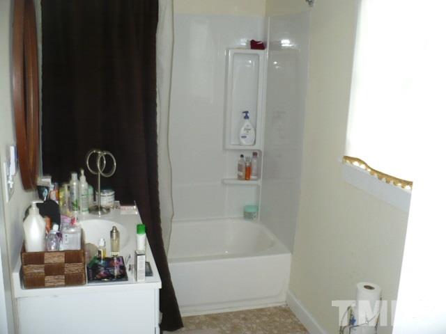 1311 Bethel Road Raleigh, NC 27610 - Photo 18 of 24 a bathroom with a sink and a mirror