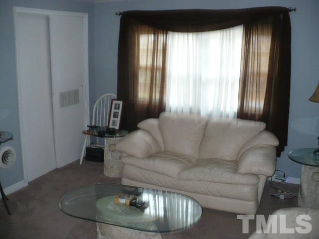 1311 Bethel Road Raleigh, NC 27610 - Photo 21 of 24 a living room with furniture and a large window
