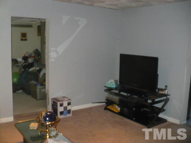 1311 Bethel Road Raleigh, NC 27610 - Photo 10 of 24 a room with furniture and a flat screen tv