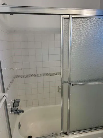 a bathroom with a shower and a bath tub