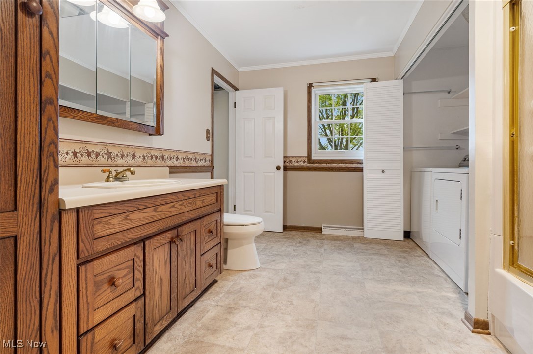14265 Reeder Avenue Northeast Alliance, OH 44601 - Photo 13 of 39 Bathroom with vanity, crown molding, and separate washer and dryer