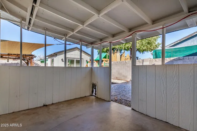 an empty room with wooden floor and closet area