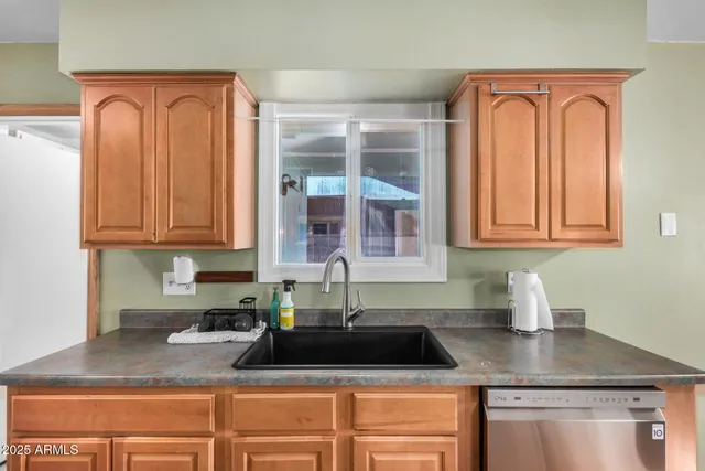 a kitchen with stainless steel appliances a sink a stove and a refrigerator