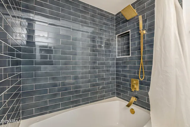 a bathroom with a granite countertop toilet sink and mirror