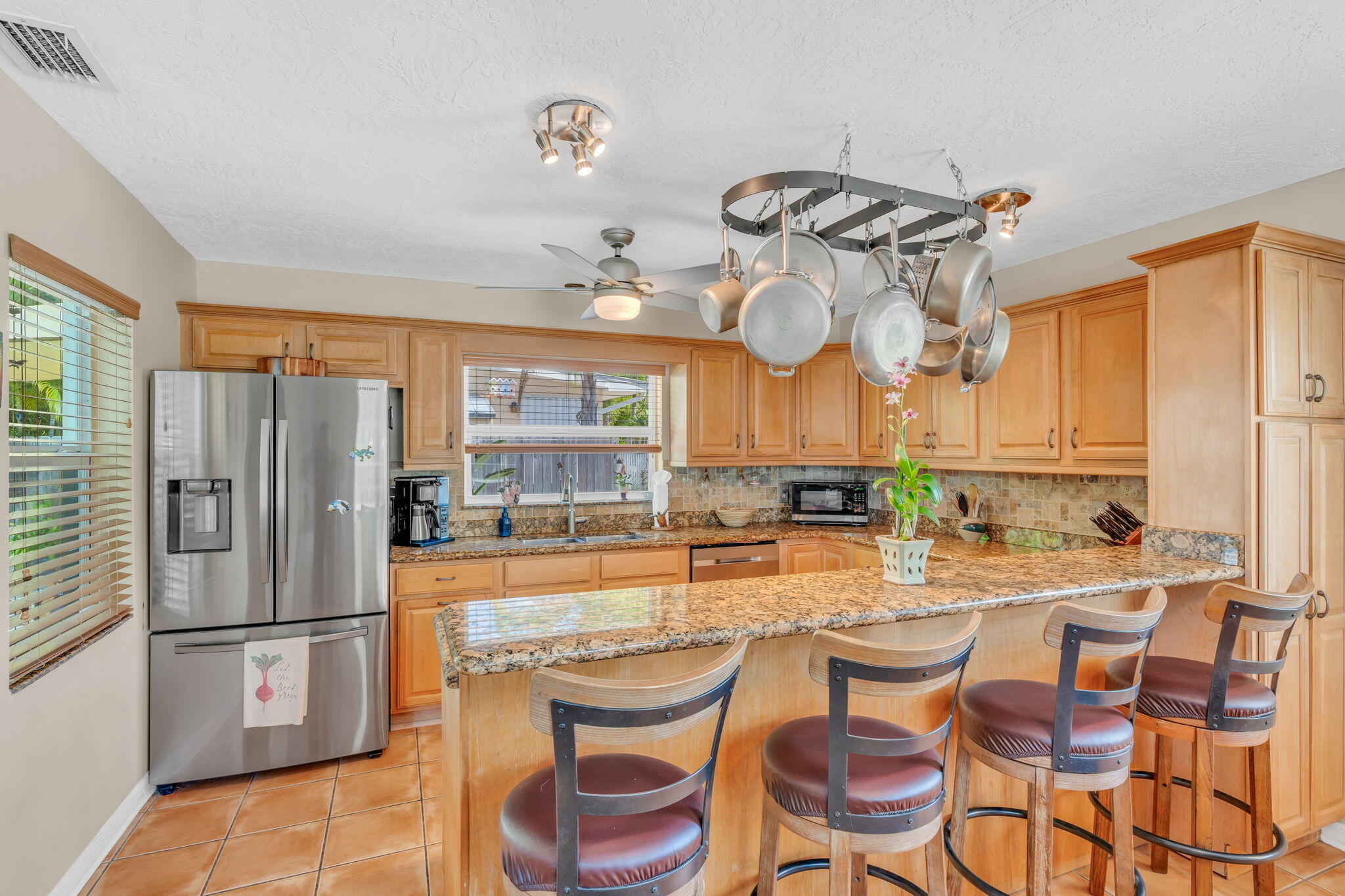 321 3rd Road Key Largo, FL 33037 - Photo 17 of 45 a kitchen with stainless steel appliances granite countertop a sink and a refrigerator