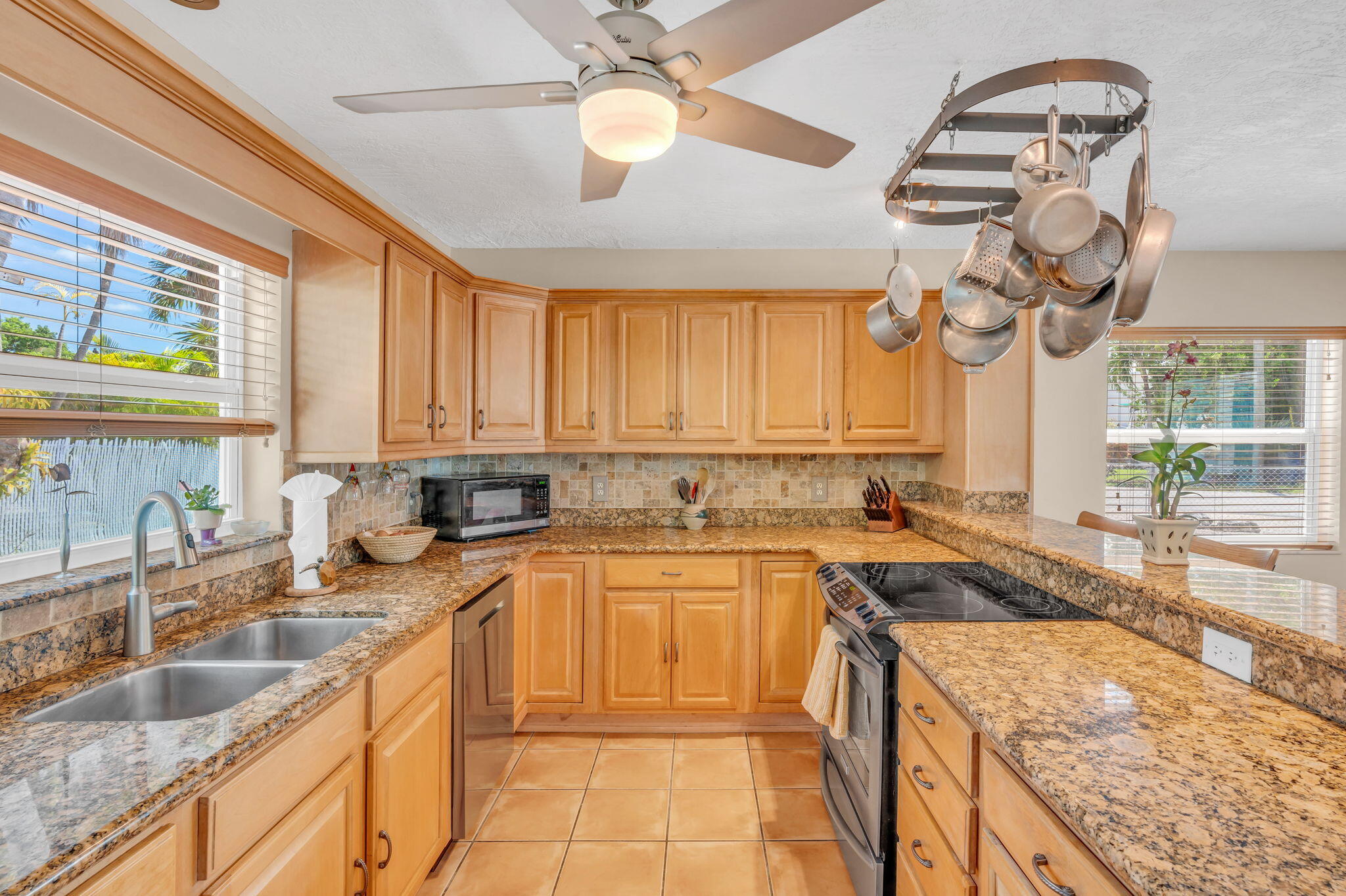 321 3rd Road Key Largo, FL 33037 - Photo 18 of 45 a kitchen with a sink a counter top space cabinets and a large window