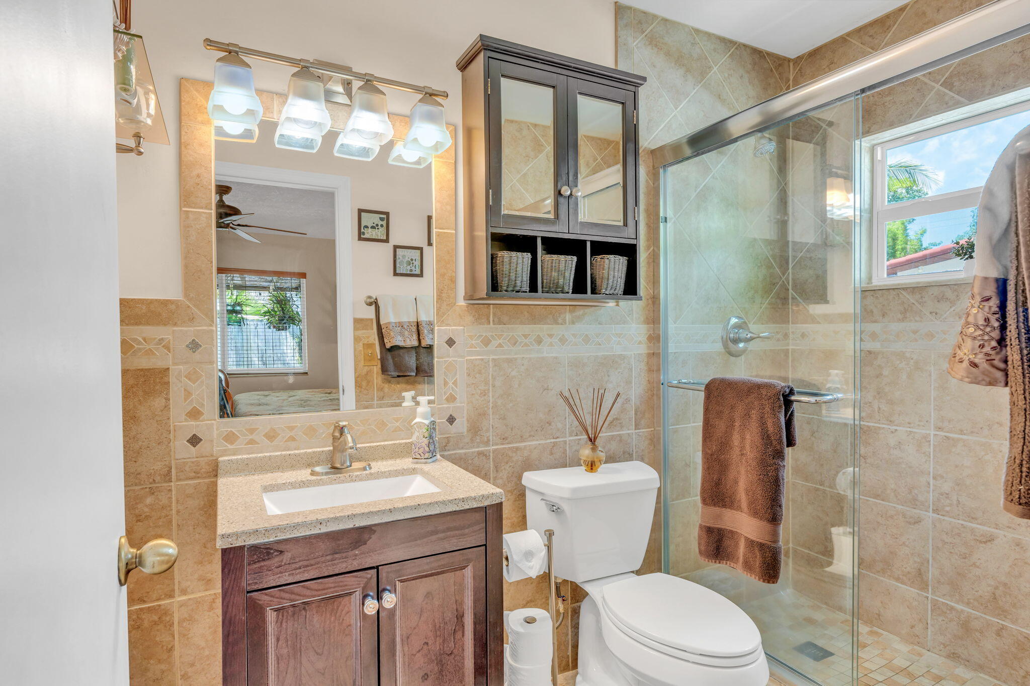 321 3rd Road Key Largo, FL 33037 - Photo 31 of 45 a bathroom with a sink a toilet a mirror a vanity and shower