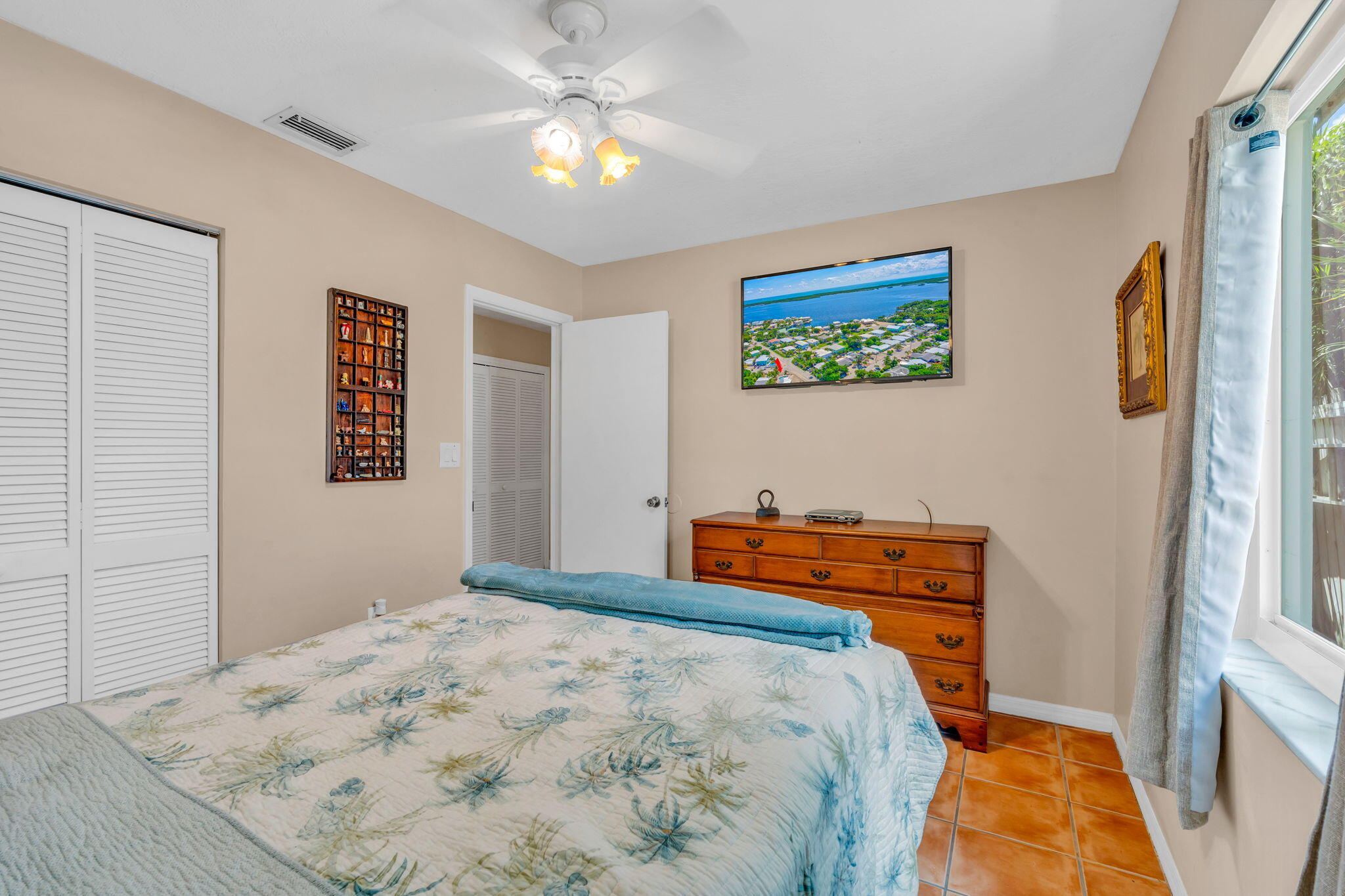 321 3rd Road Key Largo, FL 33037 - Photo 35 of 45 a bedroom with a bed and a chandelier