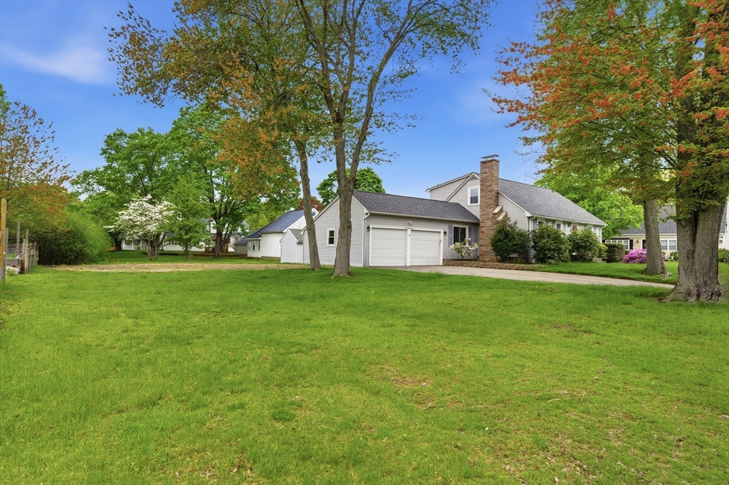 188 Glendale Road Attleboro, MA 02703 - Photo 29 of 37 a view of a white house that has a tree in the grass