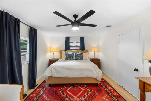 a bedroom with a bed and a window