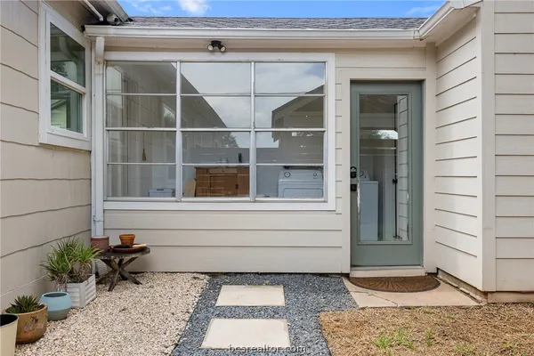 a bathroom with a window and a potted plant