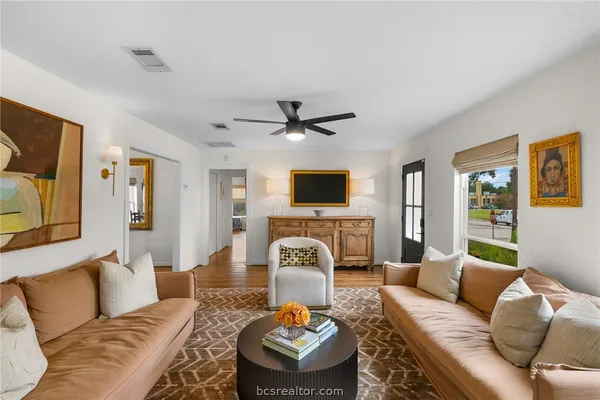 a living room with furniture and a flat screen tv