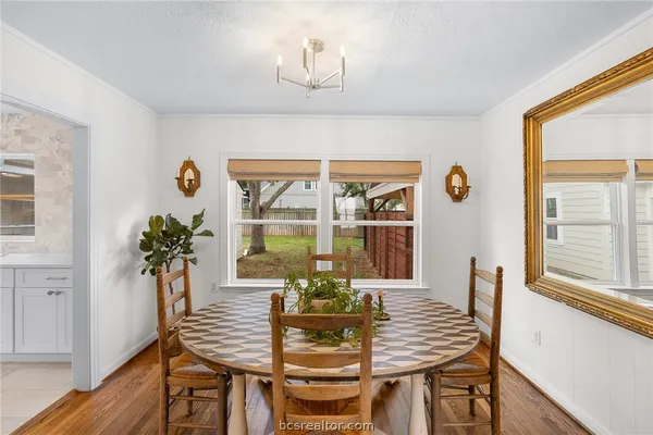 a view of a dining room with furniture wooden floor and a window