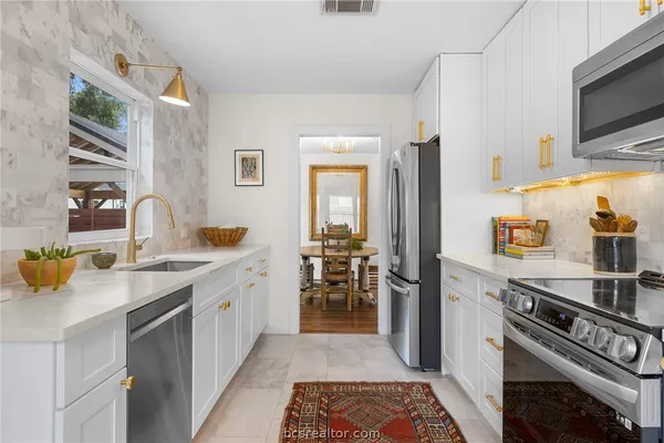a kitchen with a sink stove and refrigerator