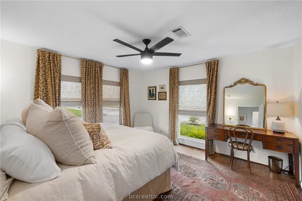 a bedroom with a bed and a large window