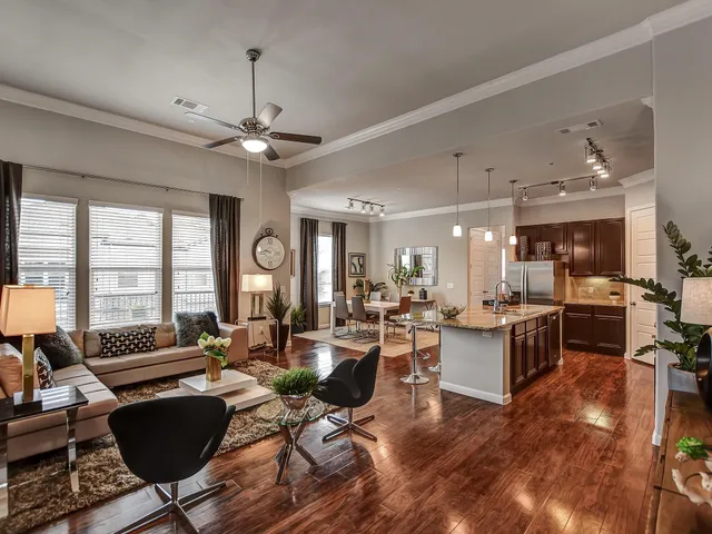 a living room with fireplace furniture and a large window