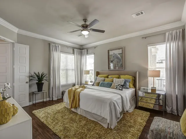 a bedroom with a large bed and a couch