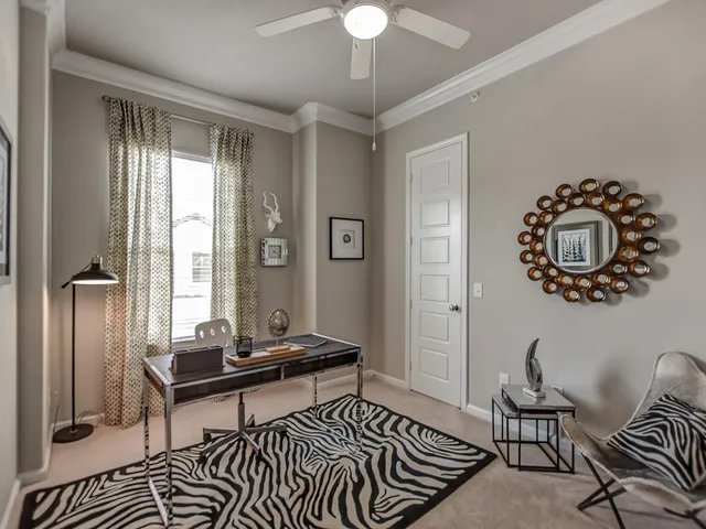 a spacious bedroom with a bed and a large window