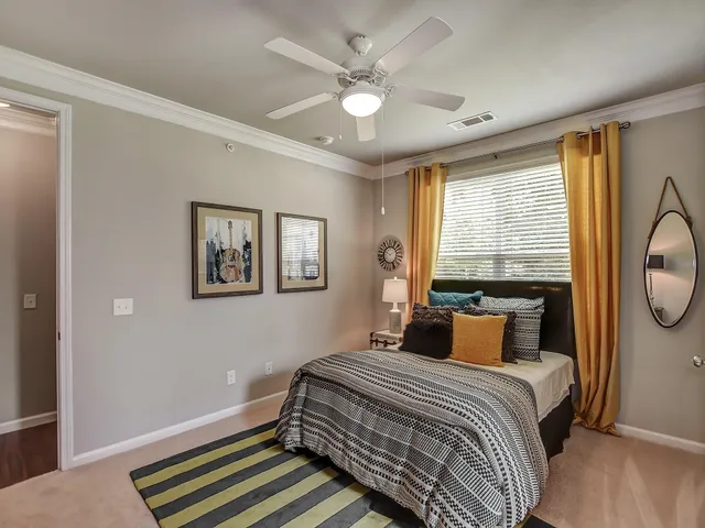 a bedroom with a large bed and a chandelier