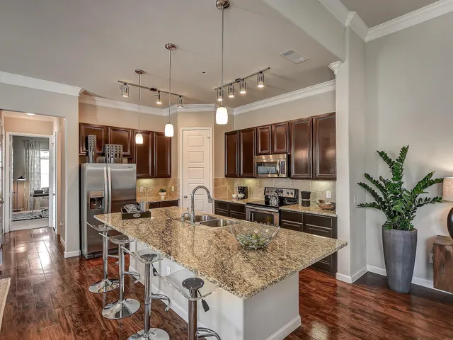 a kitchen with counter top space and wooden floor