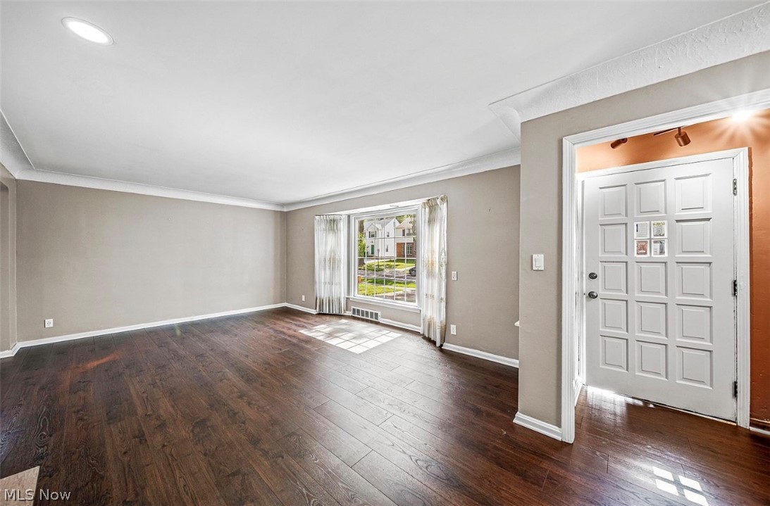 4069 Bushnell Road Cleveland, OH 44121 - Photo 6 of 39 Foyer featuring dark wood-style flooring and crown molding
