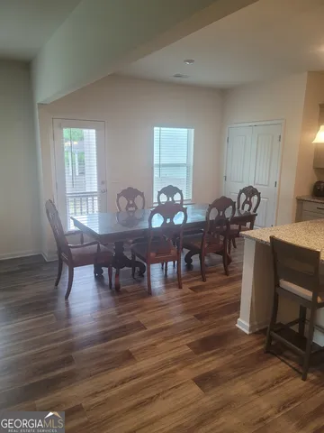 a living room with furniture a dining table and a piano