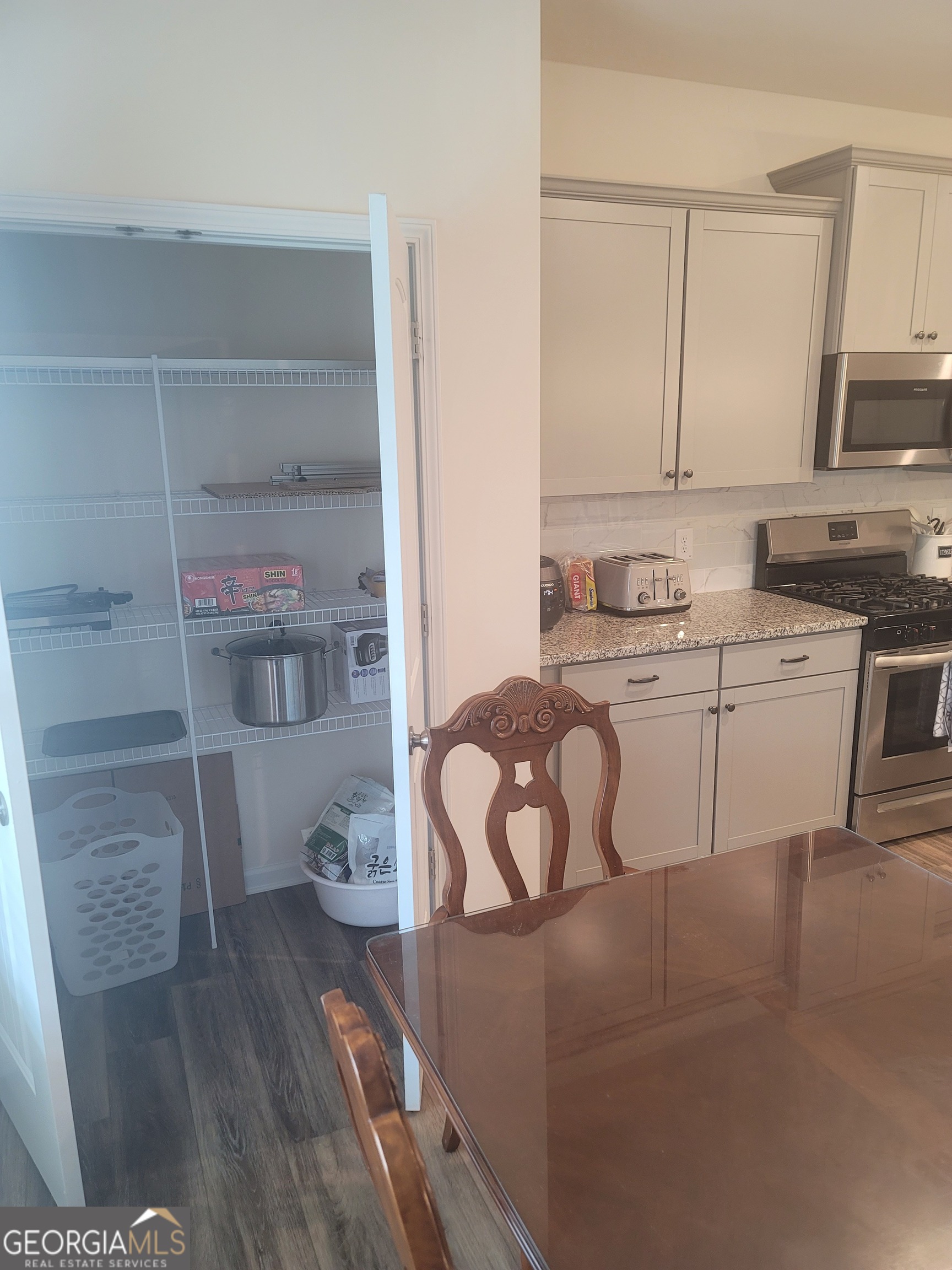 102 Potters Fields Northwest Cartersville, GA 30121 - Photo 20 of 36 a kitchen with a sink a stove cabinets and wooden floor