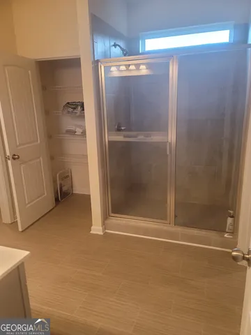 a room with a sink cabinets and wooden floor