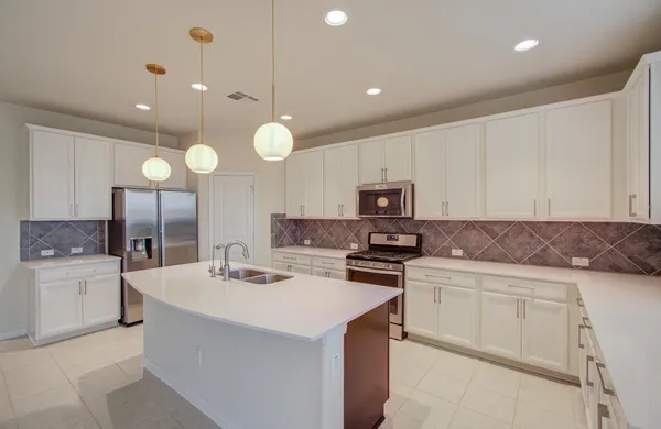 a kitchen with a sink a stove and cabinets