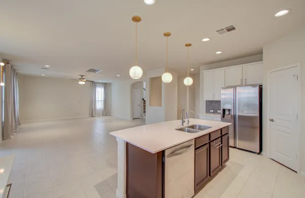 a kitchen with kitchen island a sink stainless steel appliances and cabinets