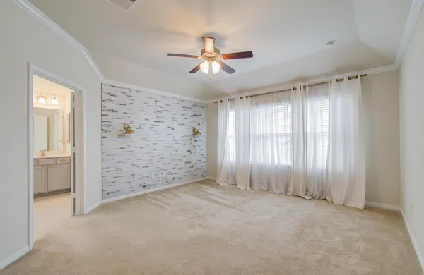 a spacious bathroom with a tub sink shower and mirror