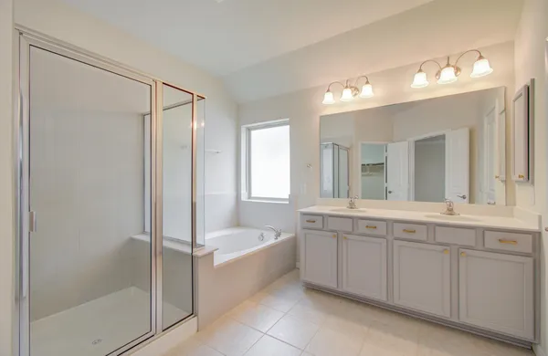 a bathroom with a shower and a glass door