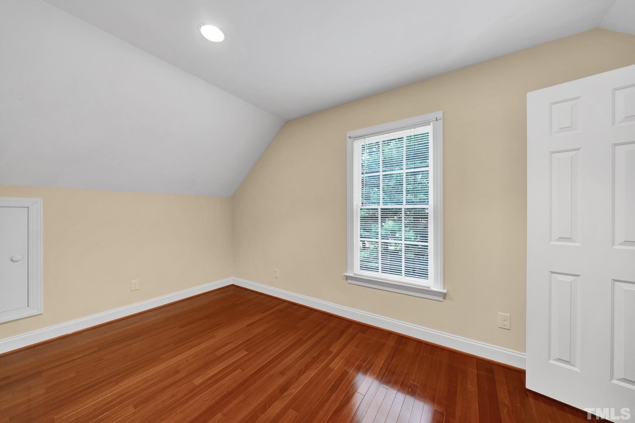 1012 Tyrrell Road Raleigh, NC 27609 - Photo 14 of 24 a view of an empty room with wooden floor and a window