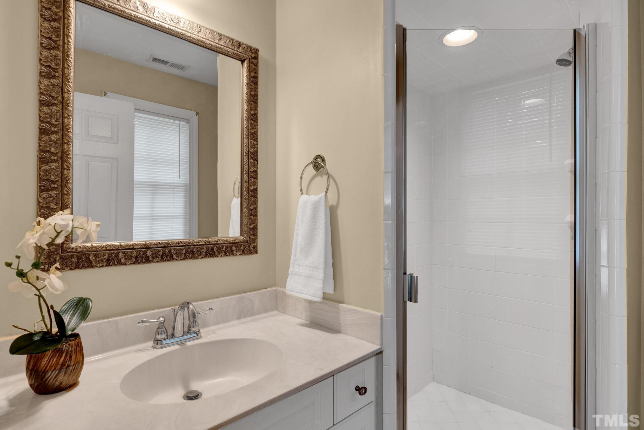 1012 Tyrrell Road Raleigh, NC 27609 - Photo 18 of 24 a bathroom with a sink and a mirror