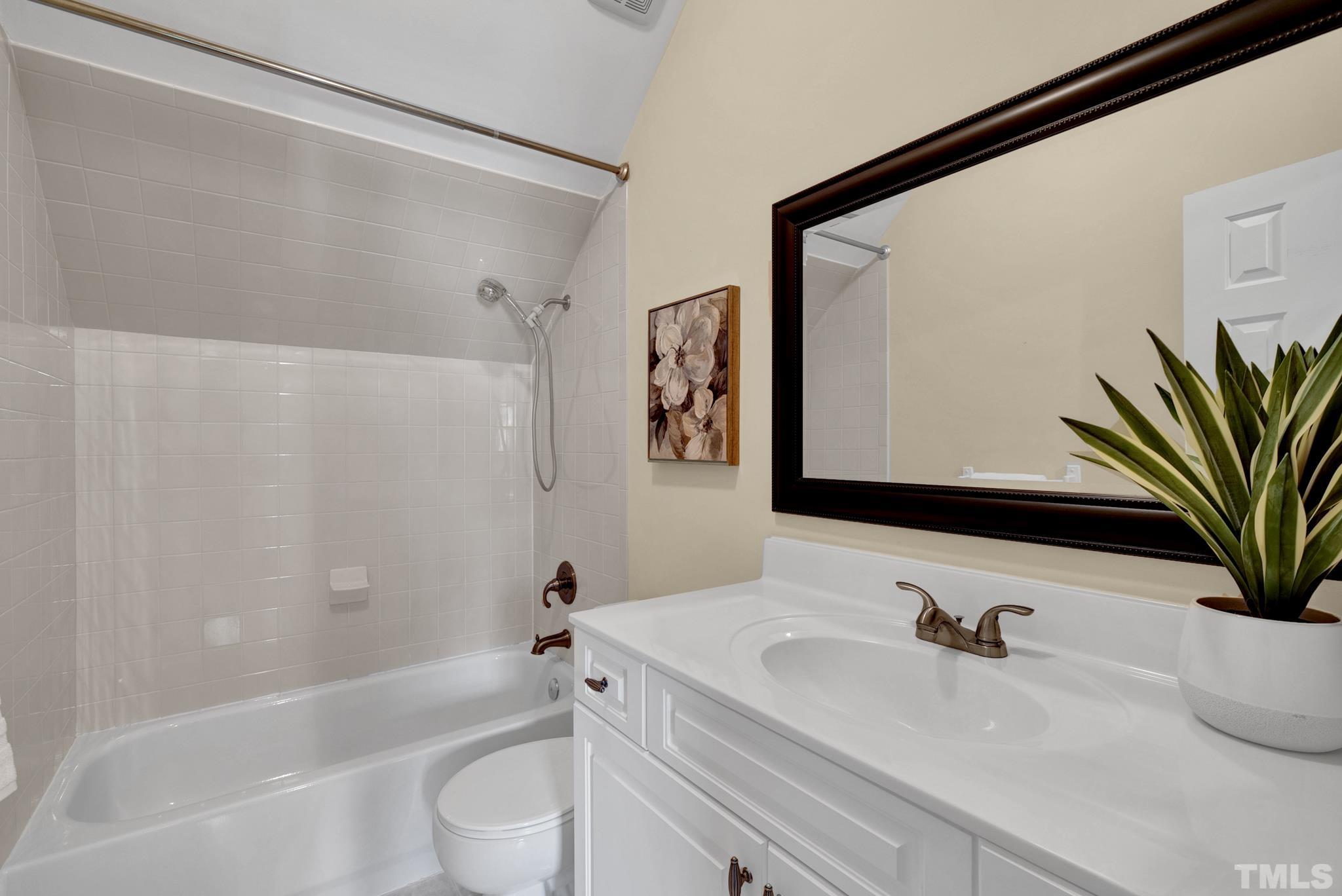 1012 Tyrrell Road Raleigh, NC 27609 - Photo 24 of 24 a bathroom with a sink a toilet and a bathtub