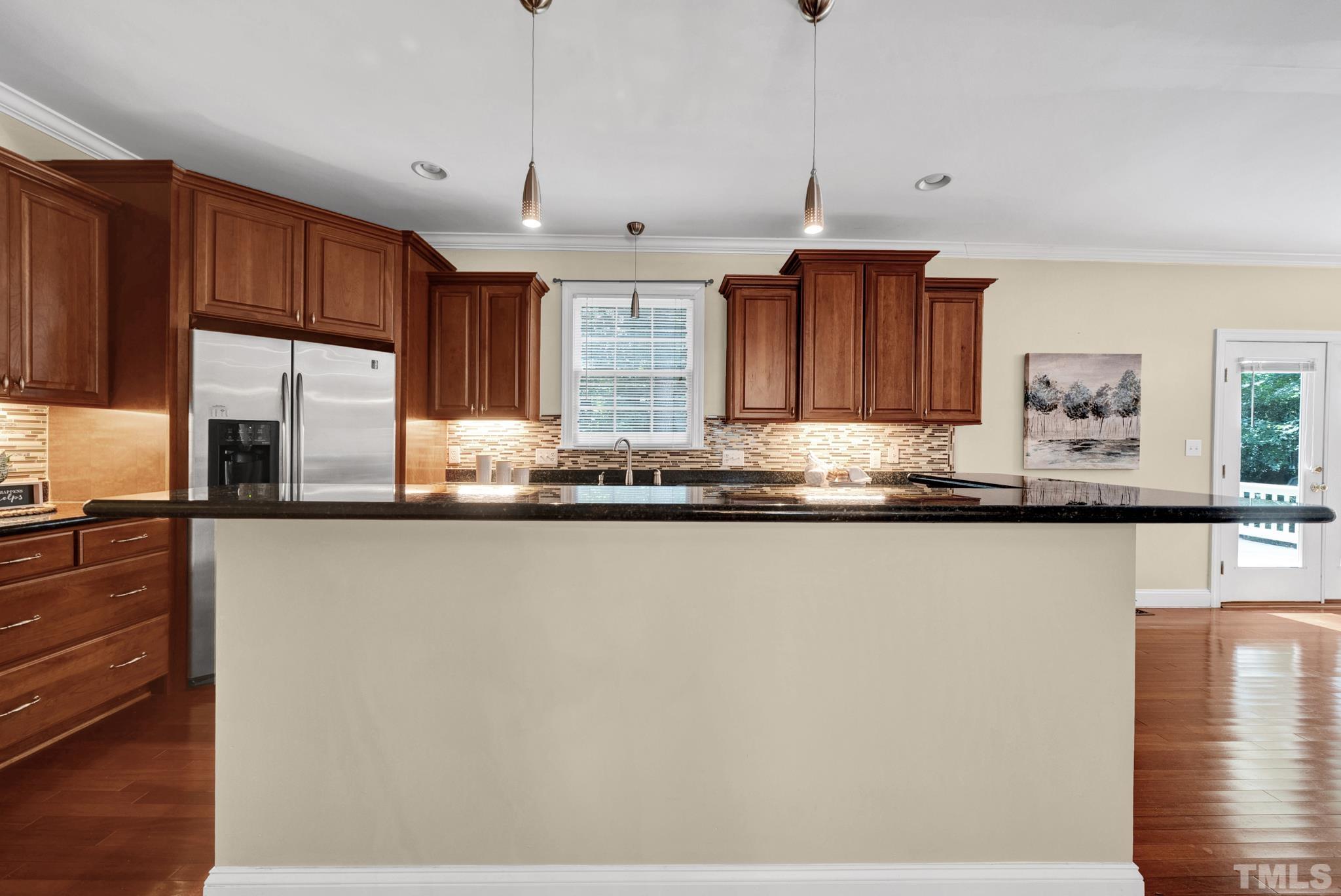 1012 Tyrrell Road Raleigh, NC 27609 - Photo 6 of 24 a kitchen with stainless steel appliances granite countertop a sink a stove and a refrigerator