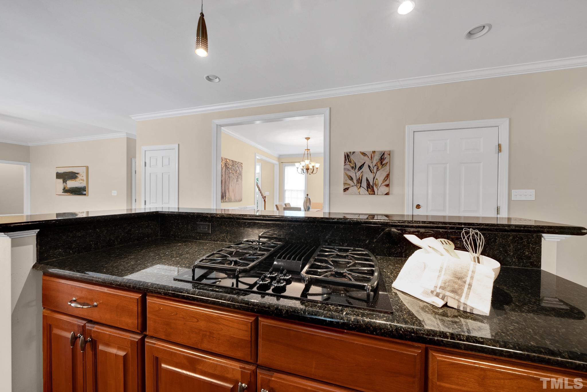 1012 Tyrrell Road Raleigh, NC 27609 - Photo 8 of 24 a kitchen with stainless steel appliances granite countertop a stove and a microwave