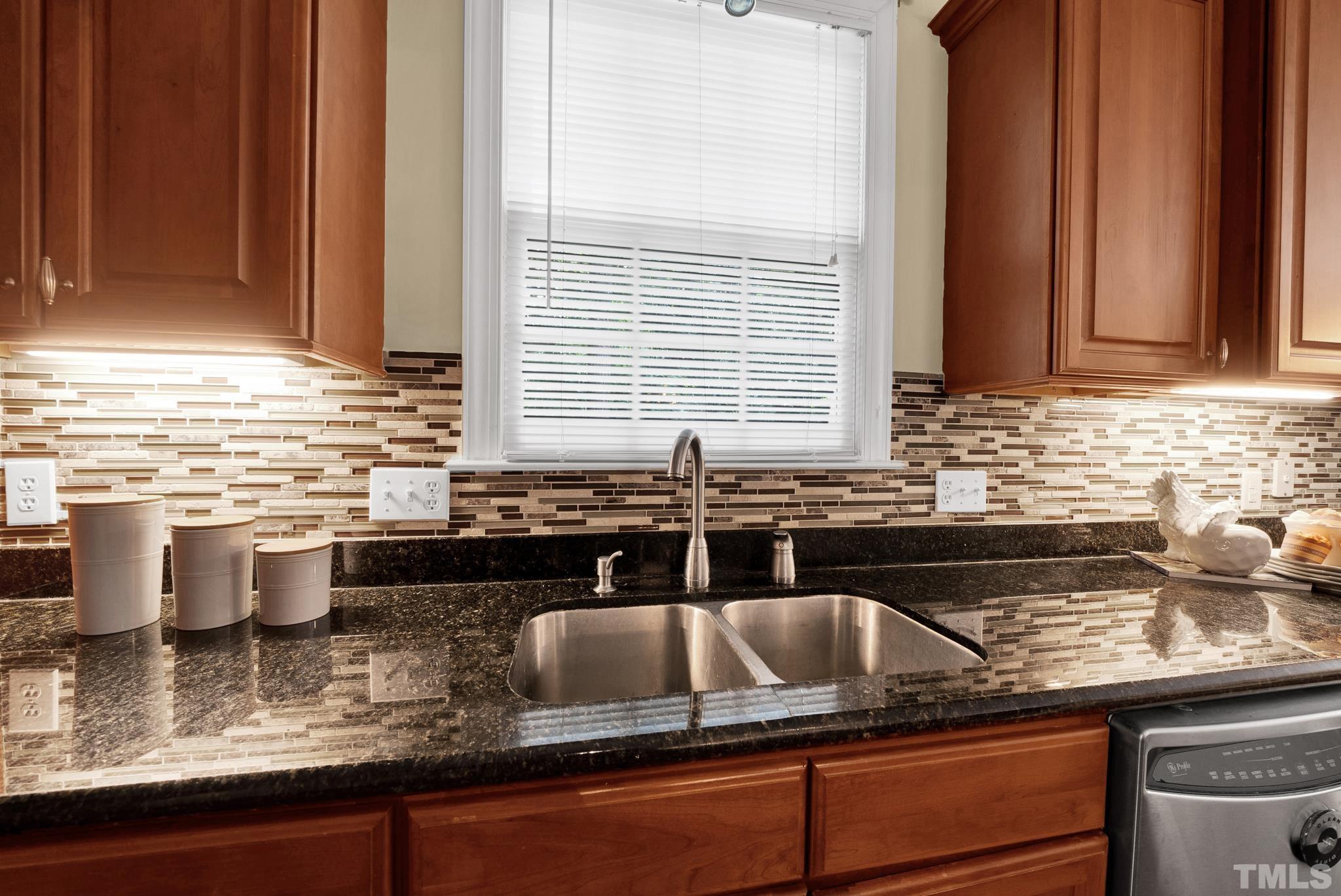 1012 Tyrrell Road Raleigh, NC 27609 - Photo 9 of 24 a kitchen with granite countertop a sink and a counter top space